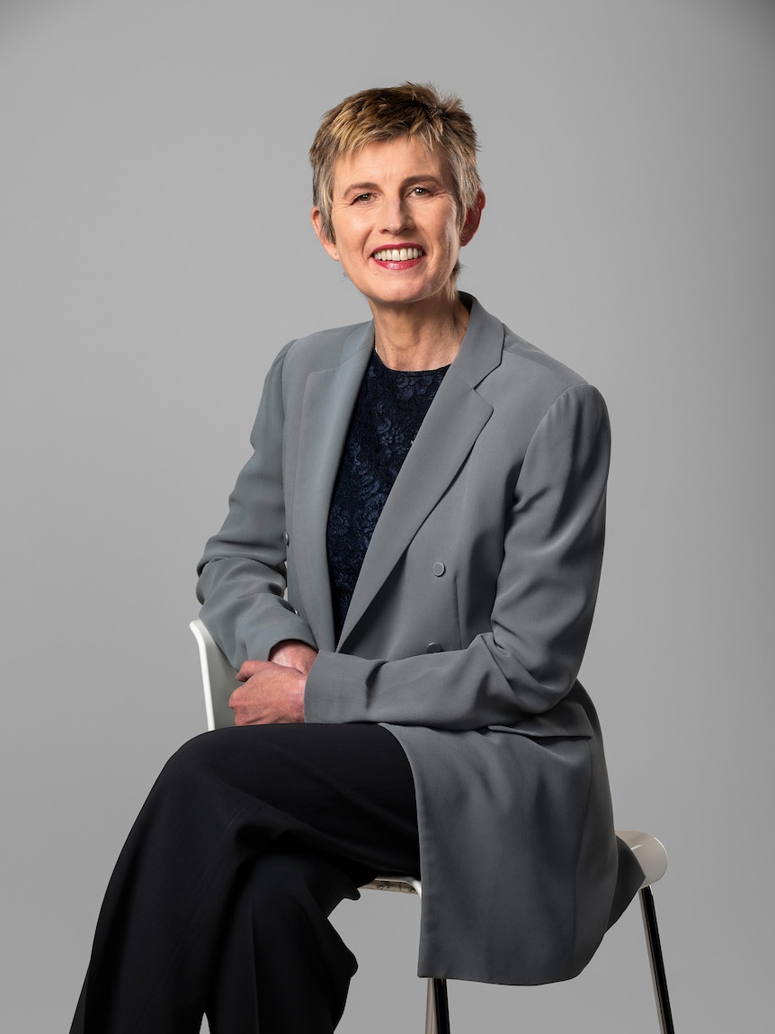 Bronwyn Evans wearing a grey suit and smiling in a business-like portrait.