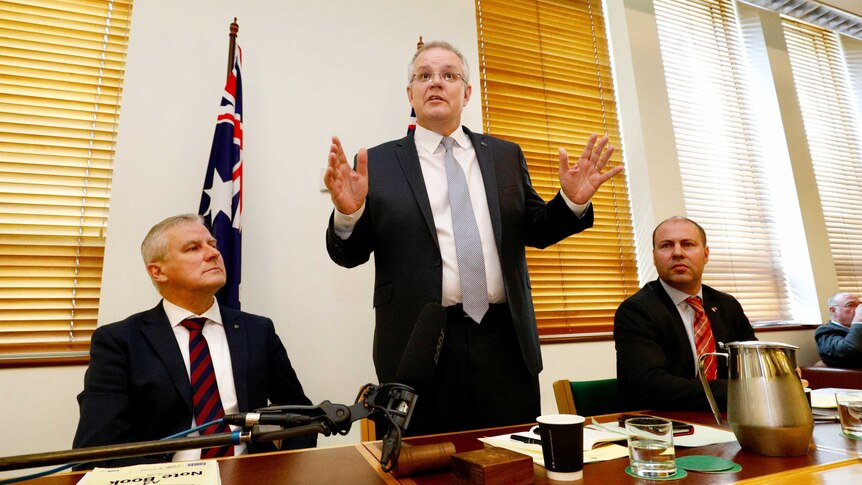 PM Morrison addresses coalition party room as Michael McCormack and Josh Frydenberg look on