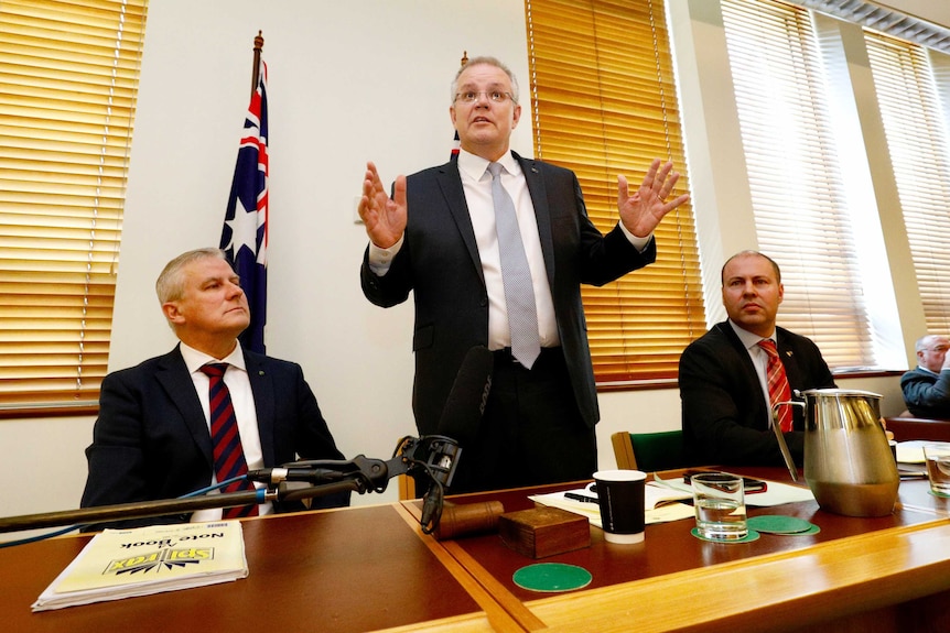 PM Morrison addresses coalition party room as Michael McCormack and Josh Frydenberg look on