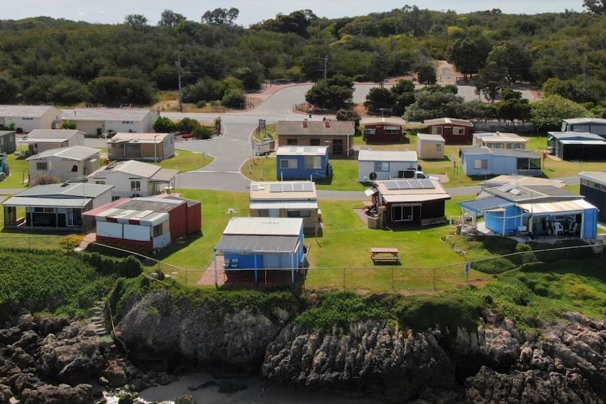 An aerial view of a cluster of shacks sitting on the shores of Cockburn Sound