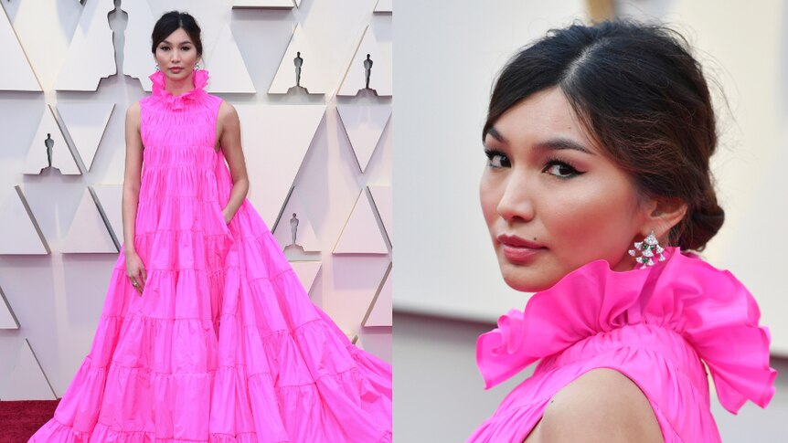 Gemma Chan wears a high-necked gown in hot pink.