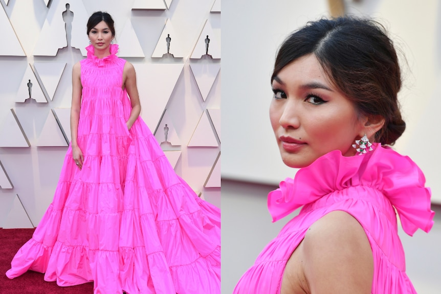 Gemma Chan wears a high-necked gown in hot pink.