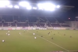 Screenshot of video of Greek soccer players and coaches making sit-down protest supporting refugees.