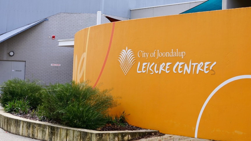 An orange wall with City of Joondalup written next to the logo and white writing "Leisure Centre" underneath.