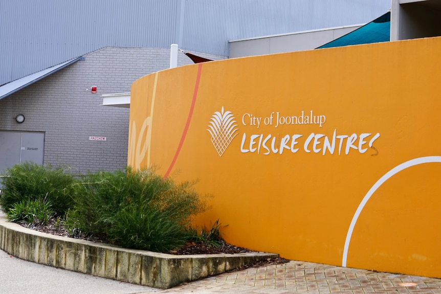 An orange wall with City of Joondalup written next to the logo and white writing "Leisure Centre" underneath.