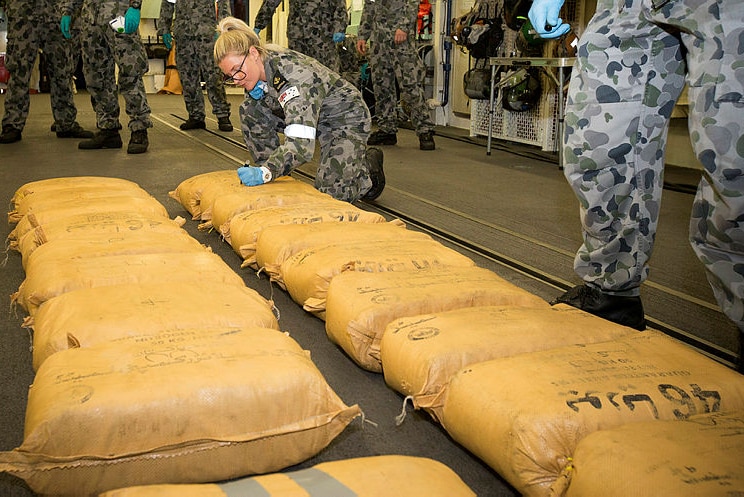 Navy seaman numbers narcotic parcels seized by HMAS Warramunga during operations in the Middle East.