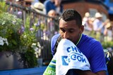 Australia's Nick Kyrgios looks dejected after retiring from match against Donald Young at Queen's.