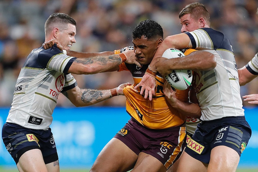 Tevita Pangai Junior fends some Cowboys