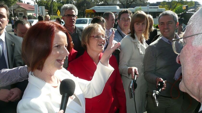 ALP candidate, Annabelle Digance, listens as Julia Gillard speaks to a member of the public