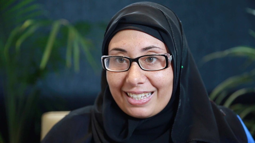 Amira, a member of Her Project, smiles at the camera