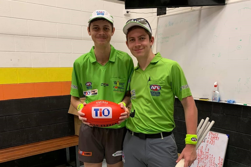 Jonty Beard hold a football in the change rooms before his first umpiring match.