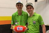 Jonty Beard hold a football in the change rooms before his first umpiring match.