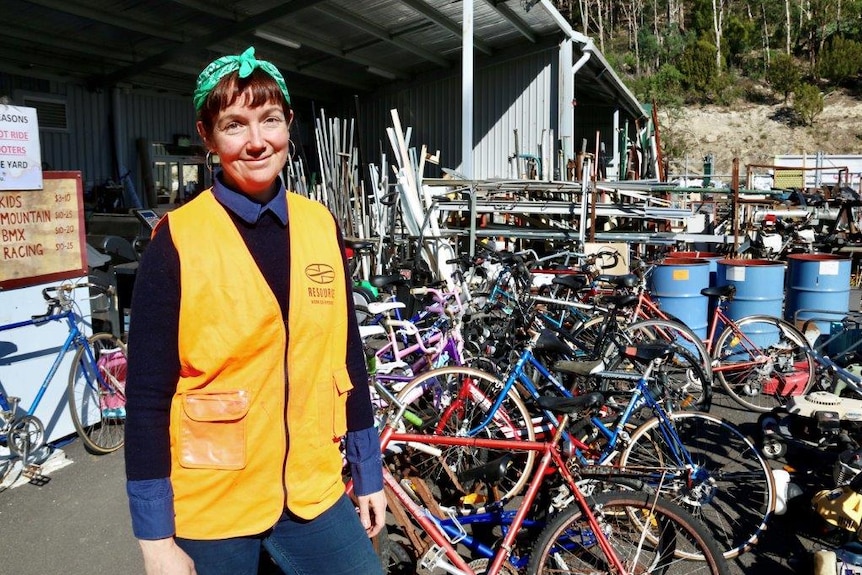 Tip shop coordinator Molly Kendall with recycled bikes