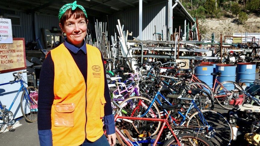 Tip shop coordinator Molly Kendall with recycled bikes