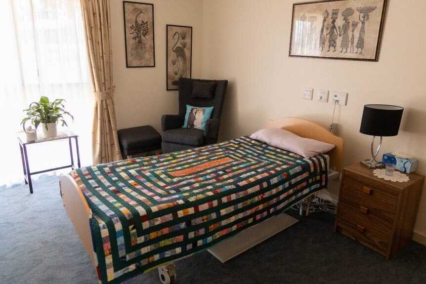 A single bed in a room at an aged care home.