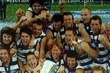 Geelong players celebrate with the Premiership Cup after their thrashing of Port Adelaide in the AFL grand final.