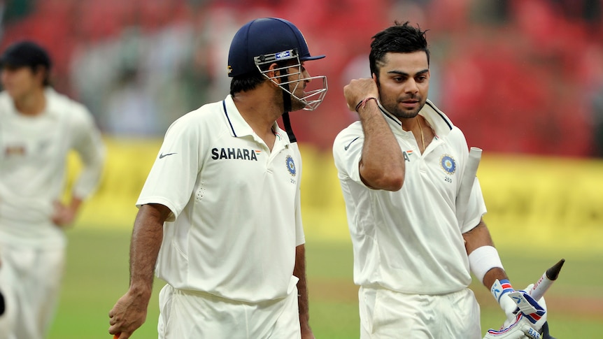 Mahendra Singh Dhoni and Virat Kohli celebrate India's Test series win over New Zealand.