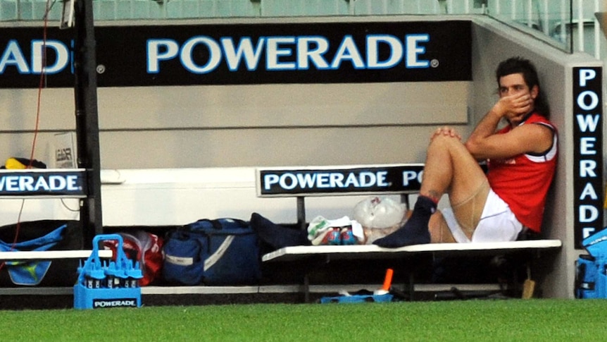 Adelaide forward Taylor Walker watches from the bench after injuring his knee against Carlton.