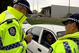 Two WA police officers in hi-vis jackets at a random traffic stop.
