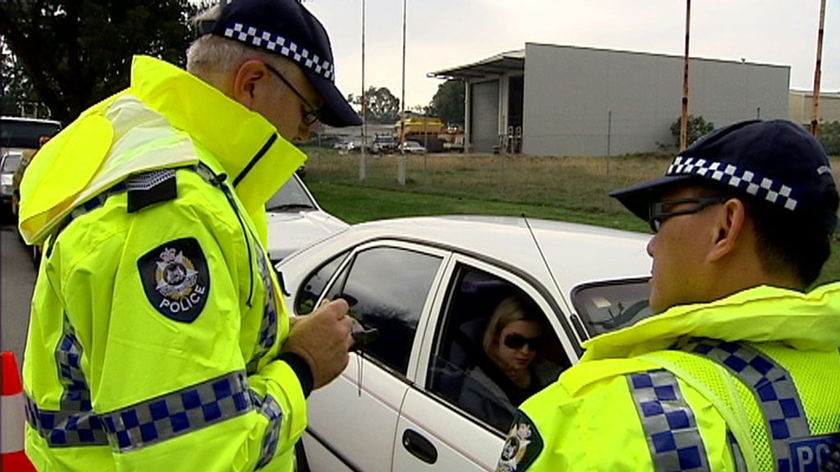 Two WA police officers in hi-vis jackets at a random traffic stop.