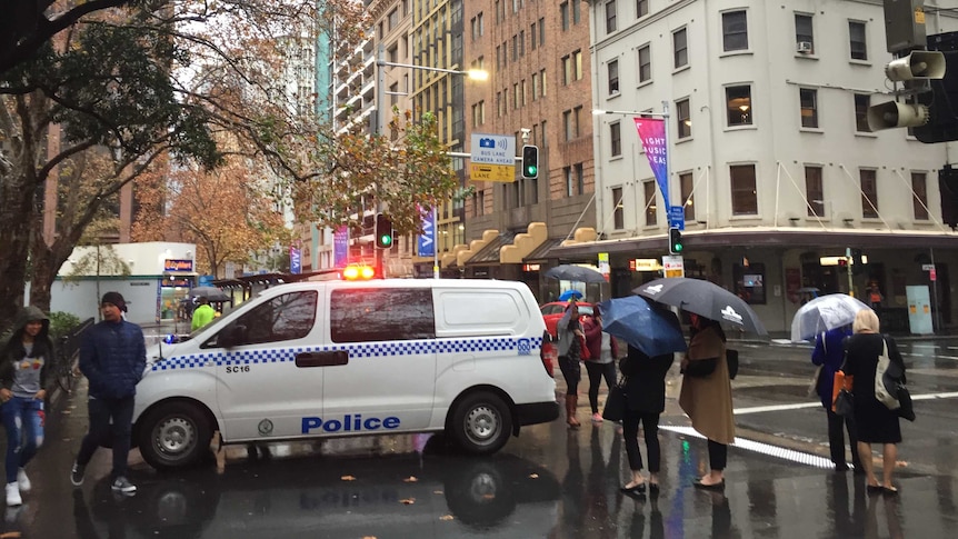 A police van and people in Sydney near Wynyard station.