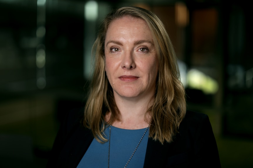 A portrait photo of Emma Dawson taken indoors in which she looks at the camera with a neutral expression.