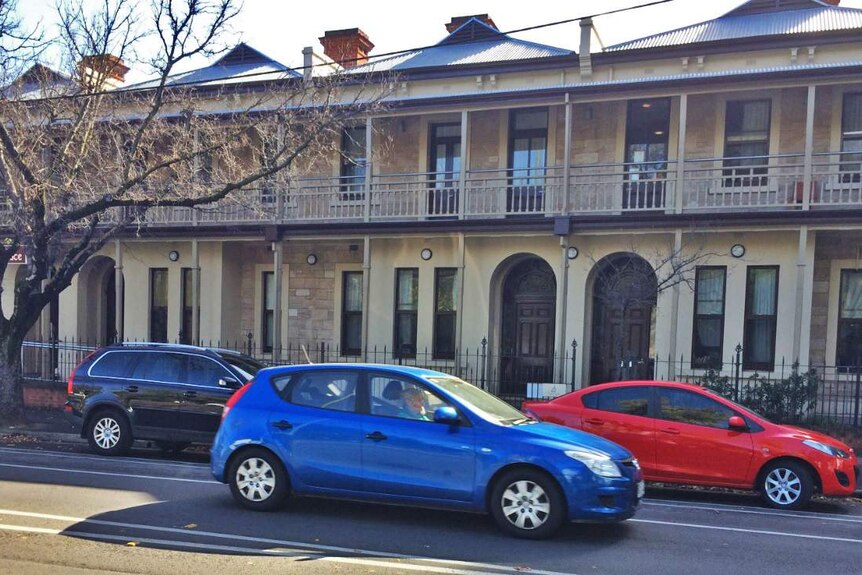 Cars in the street outside an Adelaide boarding house.