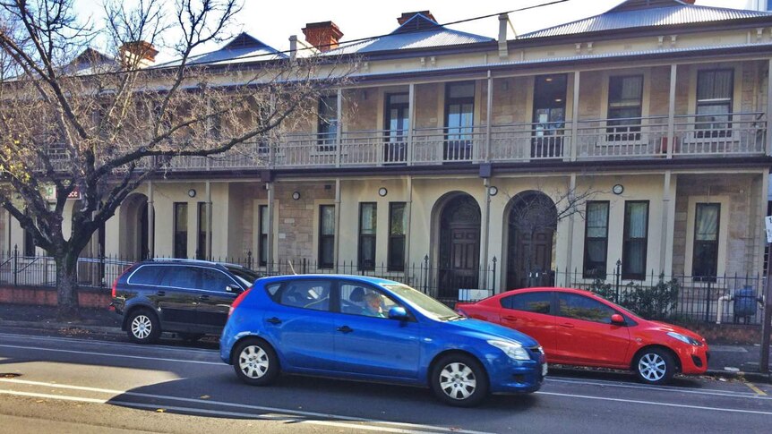 Cars in the street outside an Adelaide boarding house.