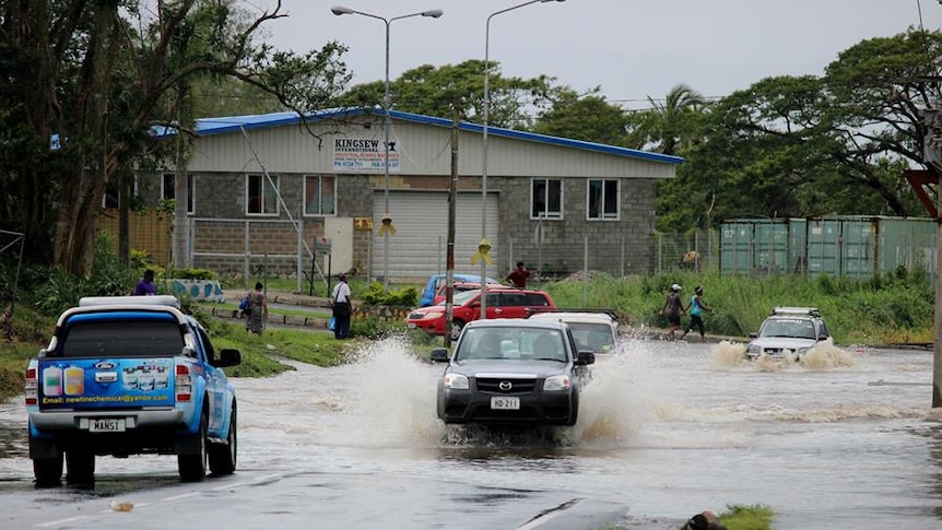 Cars drive through floodwater in Nadi.jpg