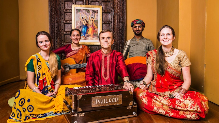 Kirtan musicians sitting with traditional instruments at Govinda's in Sydney.