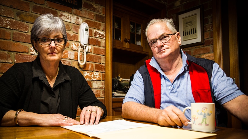 Greg and Julie Lewis sitting at their kitchen table