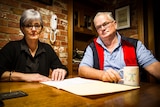 Greg and Julie Lewis sitting at their kitchen table