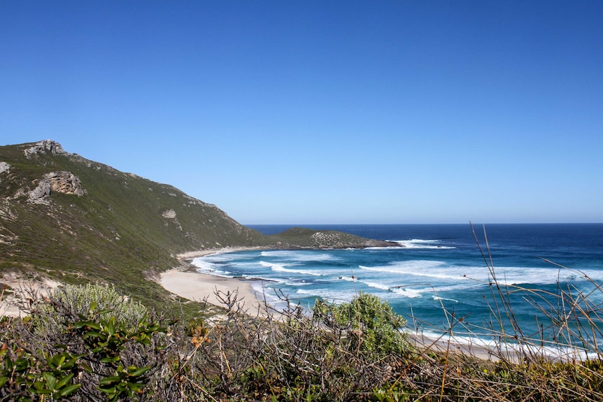 A view over a large rugged beach.