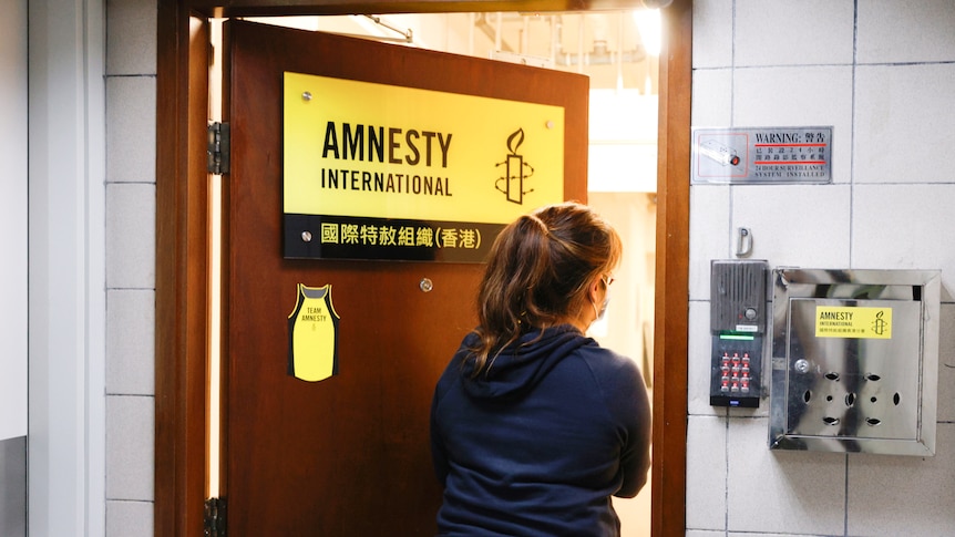 A woman enters the Amnesty International Hong Kong office