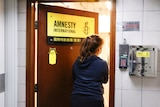 A woman enters the Amnesty International Hong Kong office