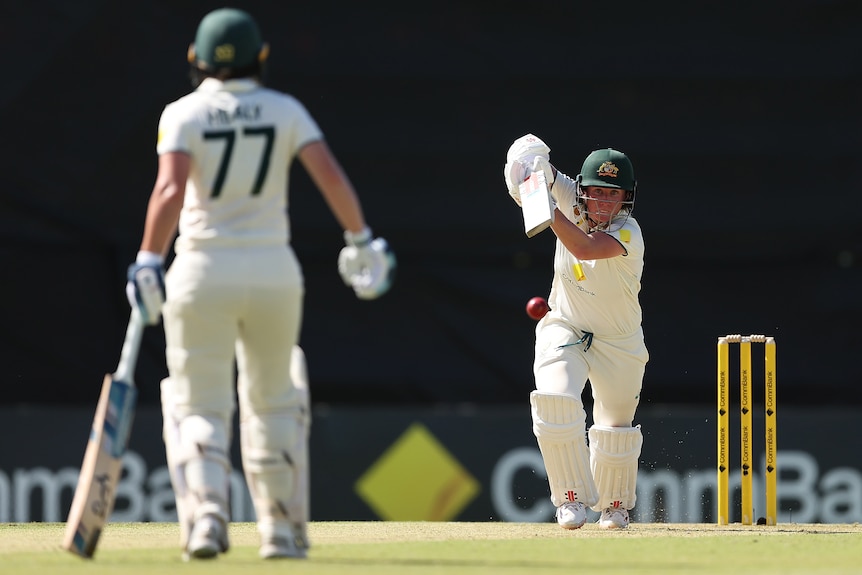 Australia batter Beth Mooney drives past Alyssa Healy during a Test against South Africa.