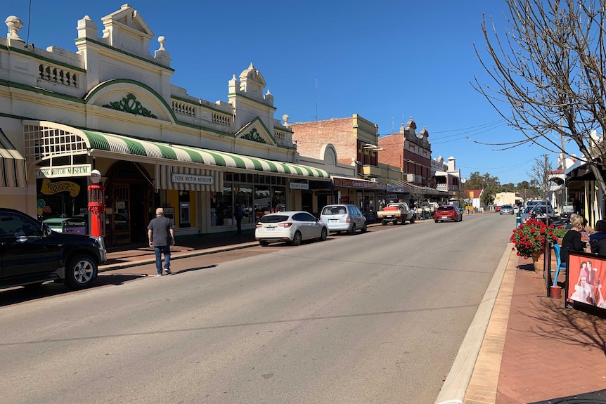 Picture of York's main strip with shops and cars.