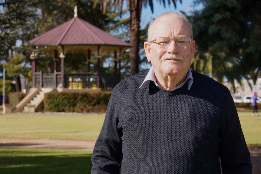 Former Forbes deputy mayor and retired agronomist Graham Falconer standing in a sunny park at Forbes.