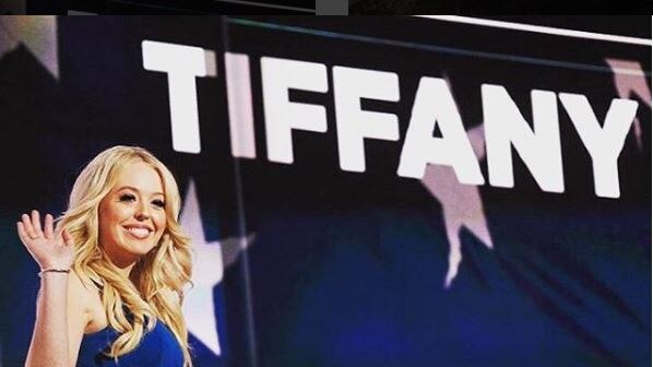 Tiffany Trump at the Republican convention waving at the crowd with her name in the background