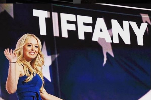 Tiffany Trump at the Republican convention waving at the crowd with her name in the background