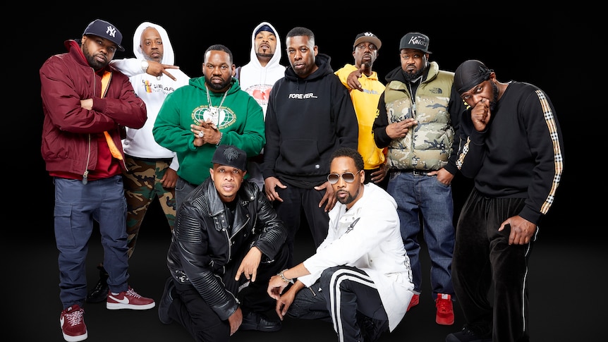 Ten members of Wu-Tang Clan gathered together in front of a pitch black background