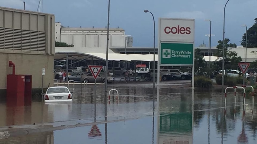 A flooded street in Port Lincoln, including a half-submerged car.