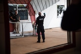 Police looking at a break in through a dark window