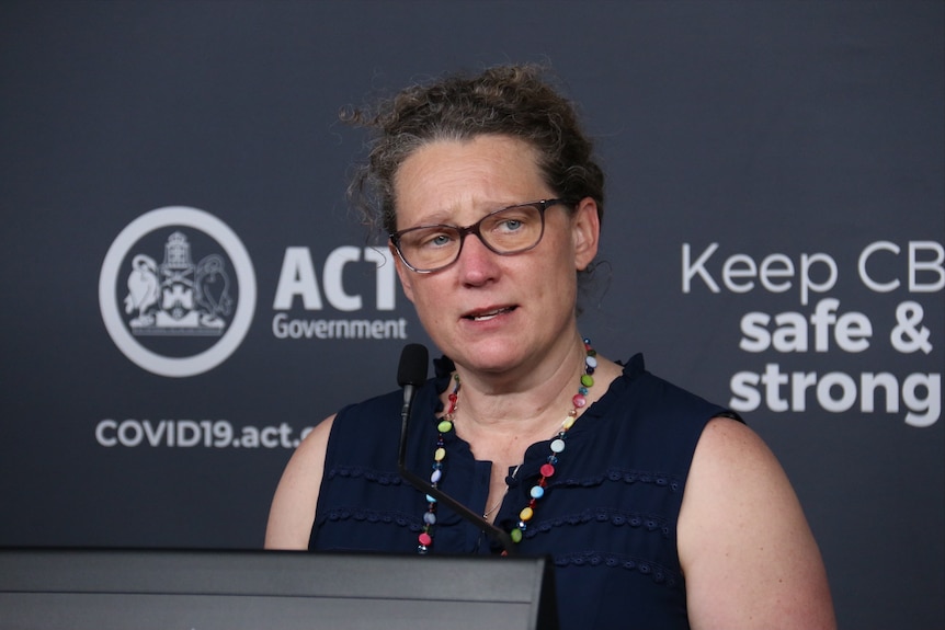 A woman speaks at a podium.