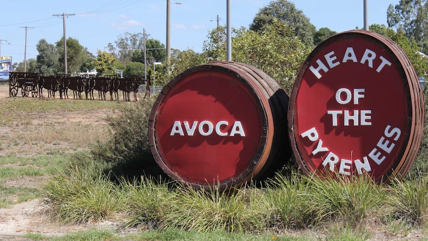 red Wine Barrels sculptures with an Avoca sign sit in the main street of a rural town