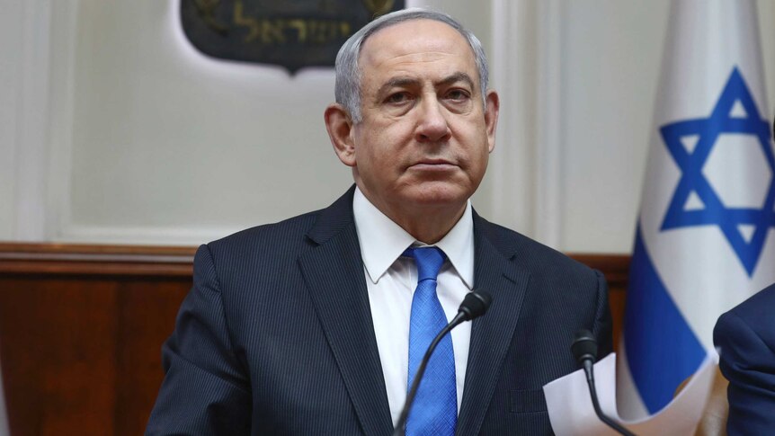 Israeli Prime Minister Benjamin Netanyahu looks at the camera sternly.