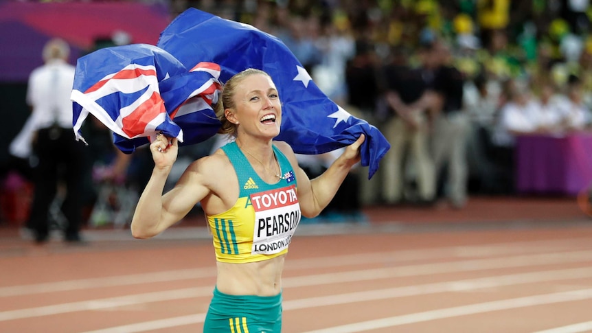Sally Pearson celebrates while carrying Australian flag at the 2017 World Athletics Championships.