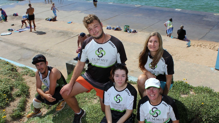 Young people beside an ocean pool