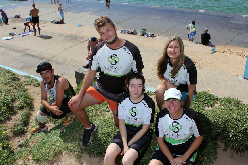 Young people beside an ocean pool