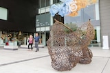 A bronze sculpture in the shape of a fishing net outside GOMA.